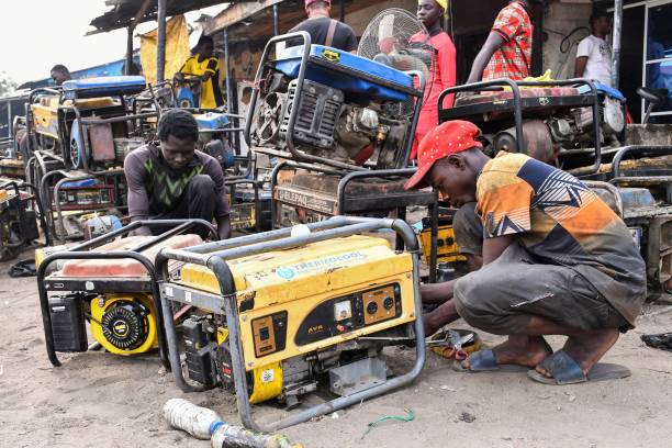 Young boys work on a generators at a workshop in the Bulabulin area of Maiduguri, on February 1, 2021. - Residents of northeast Nigerian city Maiduguri have been struggling with a power blackout for a week after jihadists blew up supply lines, causing water shortages and disrupting businesses and daily life.
The attack was the third time in a month that the IS-linked Islamic State West Africa Province (ISWAP) group have plunged the entire city of three million into darkness for days by blowing up transmission lines. (Photo by Audu Marte / AFP) (Photo by AUDU MARTE/AFP via Getty Images)