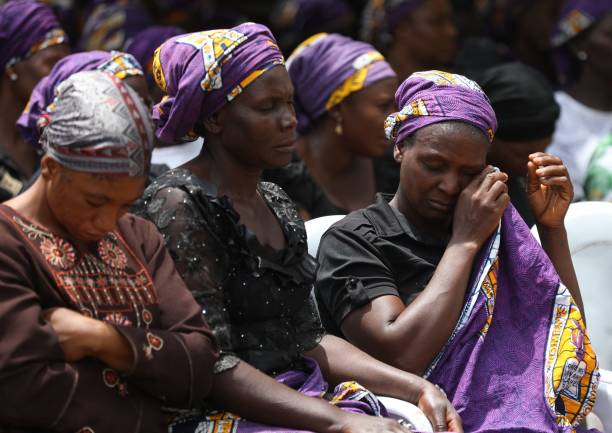 Parents of abducted students of Bethel Baptist High School sit inside the school premises to pray for the return of their children whom were abducted by gunmen in the Chikun Local Government Area of Kaduna state, northwest Nigeria on July 14, 2021. - The girls are just two of the more than 100 Nigerian children snatched from Bethel Baptist High School nearly three weeks ago, herded by gunmen into the forests after a kidnapping raid on their dormitories.
The July 5 attack in Nigeria's northwest Kaduna state was just the latest mass abduction at a school or college as kidnap gangs seeking quick ransoms zero in on soft target of young students.
Armed kidnappings for ransom along highways, and from homes and businesses now make almost daily newspaper headlines in Africa's most populous country. (Photo by Kola Sulaimon / AFP) (Photo by KOLA SULAIMON/AFP via Getty Images)