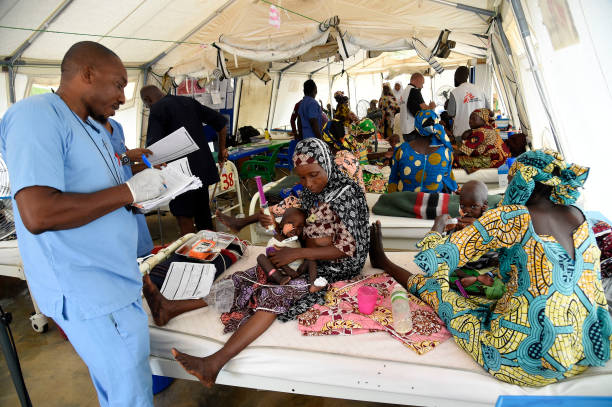 A nurse attends to mothers whose children are suffering malnutrition in a clinic set up by health authorities in collaboraion with Medecins Sans Frontieres or Doctors Without Borders (MSF)in Katsina State, northwest Nigeria, on July 20, 2022. - Rural northwest Nigeria has been ravaged by gangs of bandit militias who raid villages, loot cattle and kidnap people to hold them for ransom in camps deep in the forests that carpet large swaths of the region.
Hundreds of thousands have been displaced across the northwest and central regions, and thousands killed in violence rivalling the impact of the 13-year jihadist conflict that has killed more than 40,000 people. (Photo by PIUS UTOMI EKPEI / AFP) (Photo by PIUS UTOMI EKPEI/AFP via Getty Images)