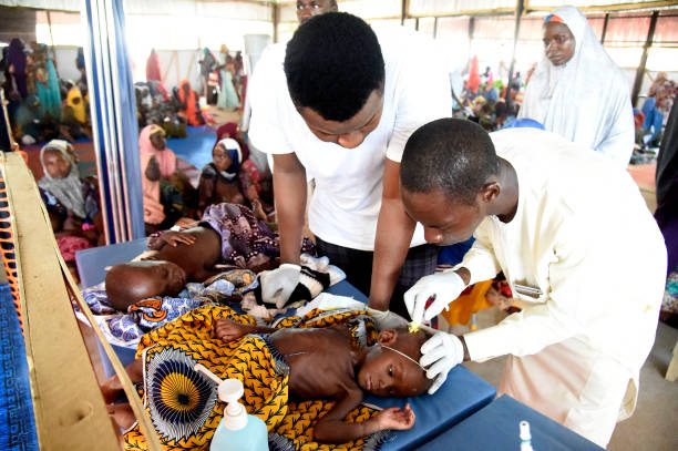 Health officials attend to children suffering malnutrition in a clinic set up by health authorities in collaboraion with Medecins Sans Frontieres or Doctors Without Borders (MSF)in Katsina State, northwest Nigeria, on July 20, 2022. - Rural northwest Nigeria has been ravaged by gangs of bandit militias who raid villages, loot cattle and kidnap people to hold them for ransom in camps deep in the forests that carpet large swaths of the region.
Hundreds of thousands have been displaced across the northwest and central regions, and thousands killed in violence rivalling the impact of the 13-year jihadist conflict that has killed more than 40,000 people. (Photo by PIUS UTOMI EKPEI / AFP) (Photo by PIUS UTOMI EKPEI/AFP via Getty Images)