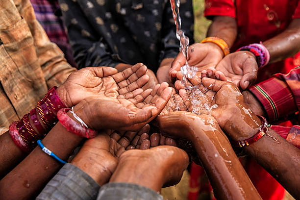 Poor African children keeping their hands up - asking for drinking water.